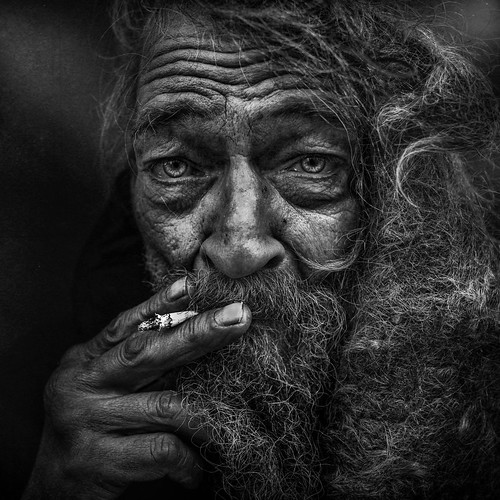 Pencil drawing - homeless man smocking with unkept hair